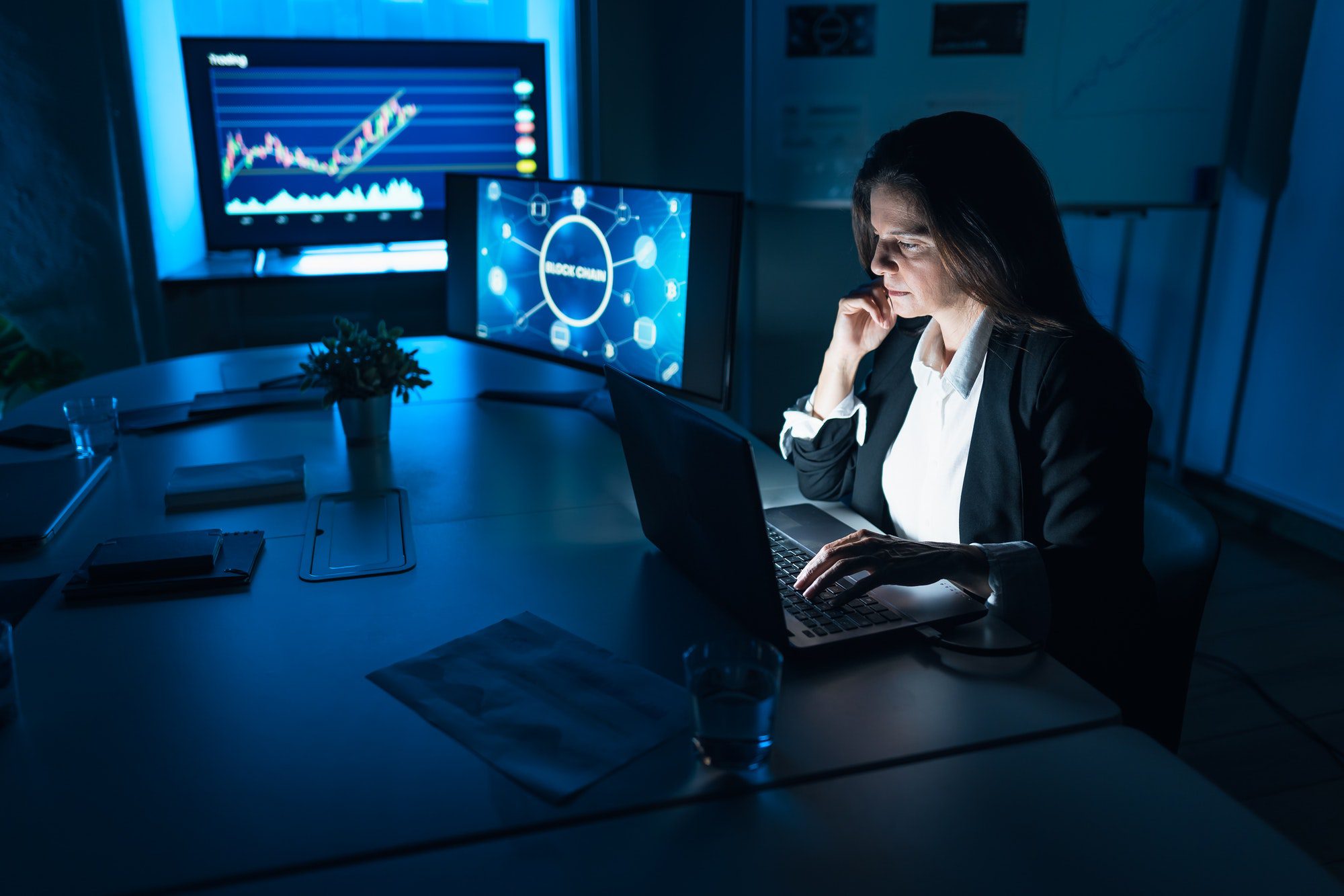 Business stock trader woman working on crypto currency markets with blockchain technology